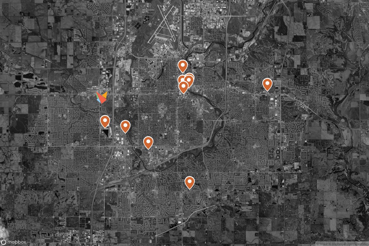 Grayscale satellite map of Sioux Falls with orange pins marking 10 breweries, from downtown to the edges of town, and the Covert fox on the west side.